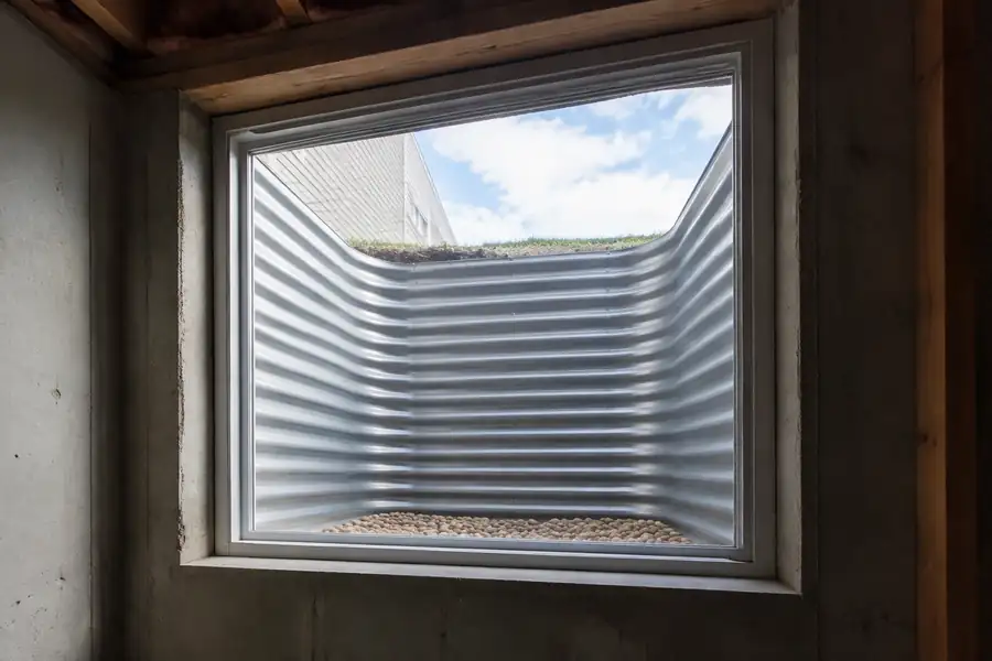 Basement egress window with a well, large enough for an adult to climb out