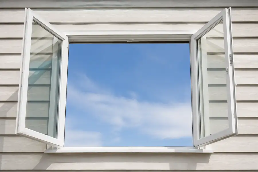 Casement egress window swung fully open, showing the full-frame clear opening